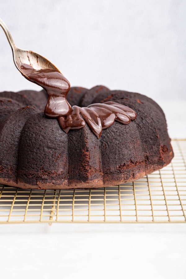 drizzling chocolate ganache over a chocolate bund cake.