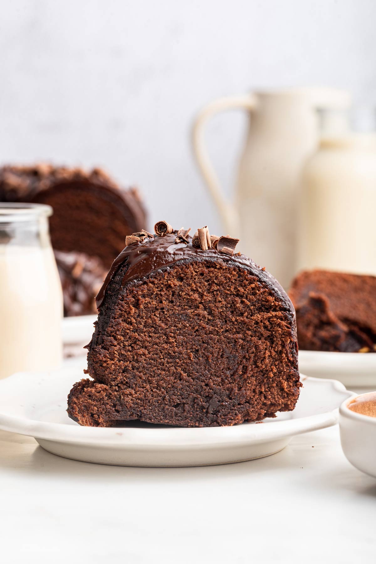 slice of chocolate bundt cake on a white dessert plate.