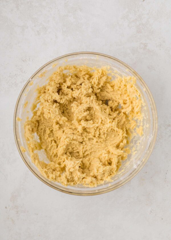 cookie dough in a glass mixing bowl