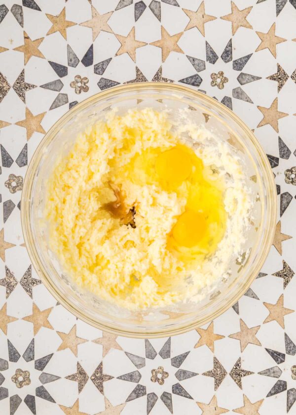 mixing eggs and vanilla into cookie batter.