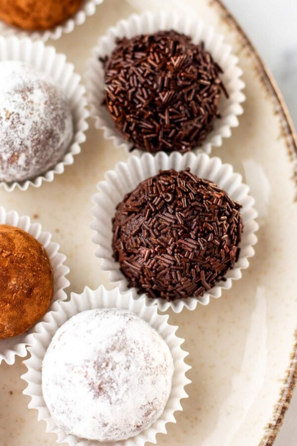 close up view of bourbon balls rolled in chocolate sprinkles.