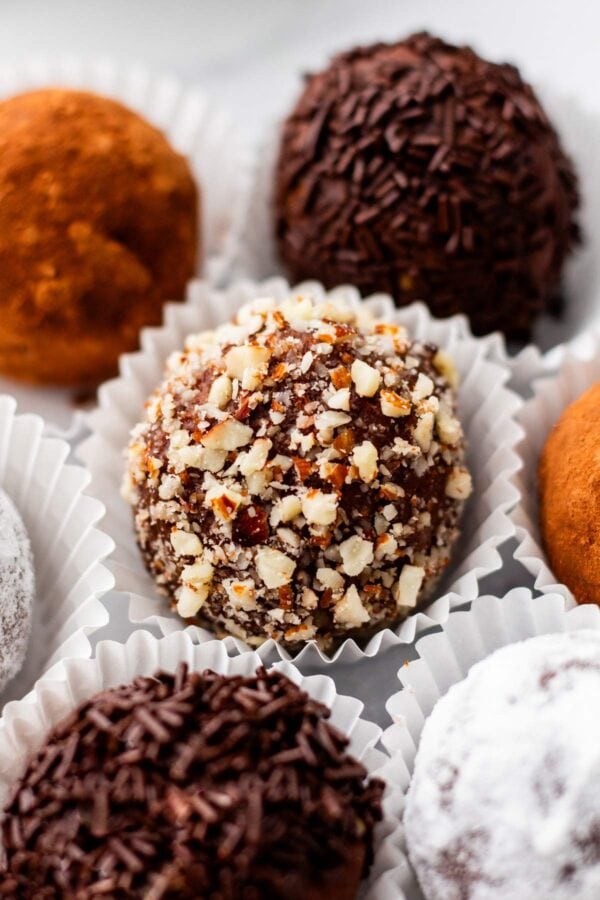 close up view of bourbon balls rolled in chopped pecans.