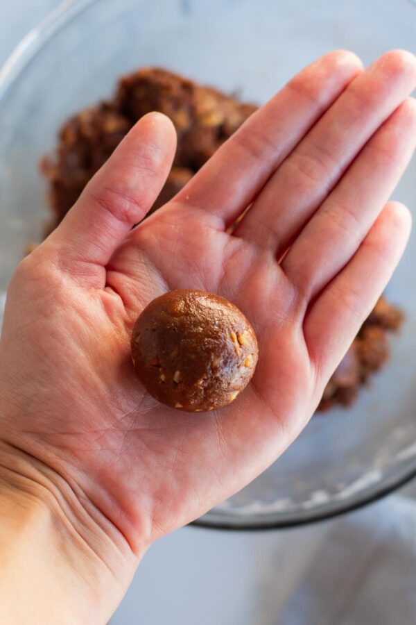 rolling bourbon balls in a palm.
