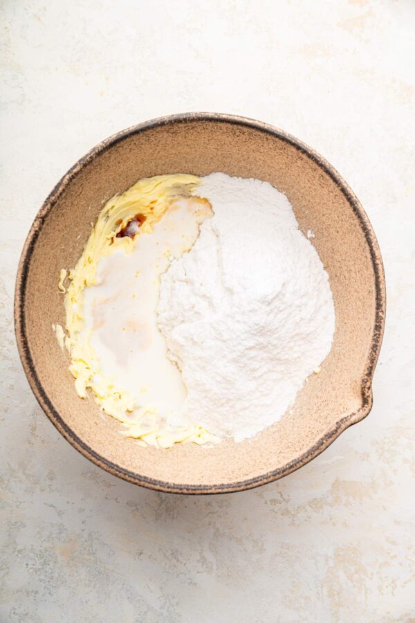 butter, powdered sugar, and milk in a mixing bowl.