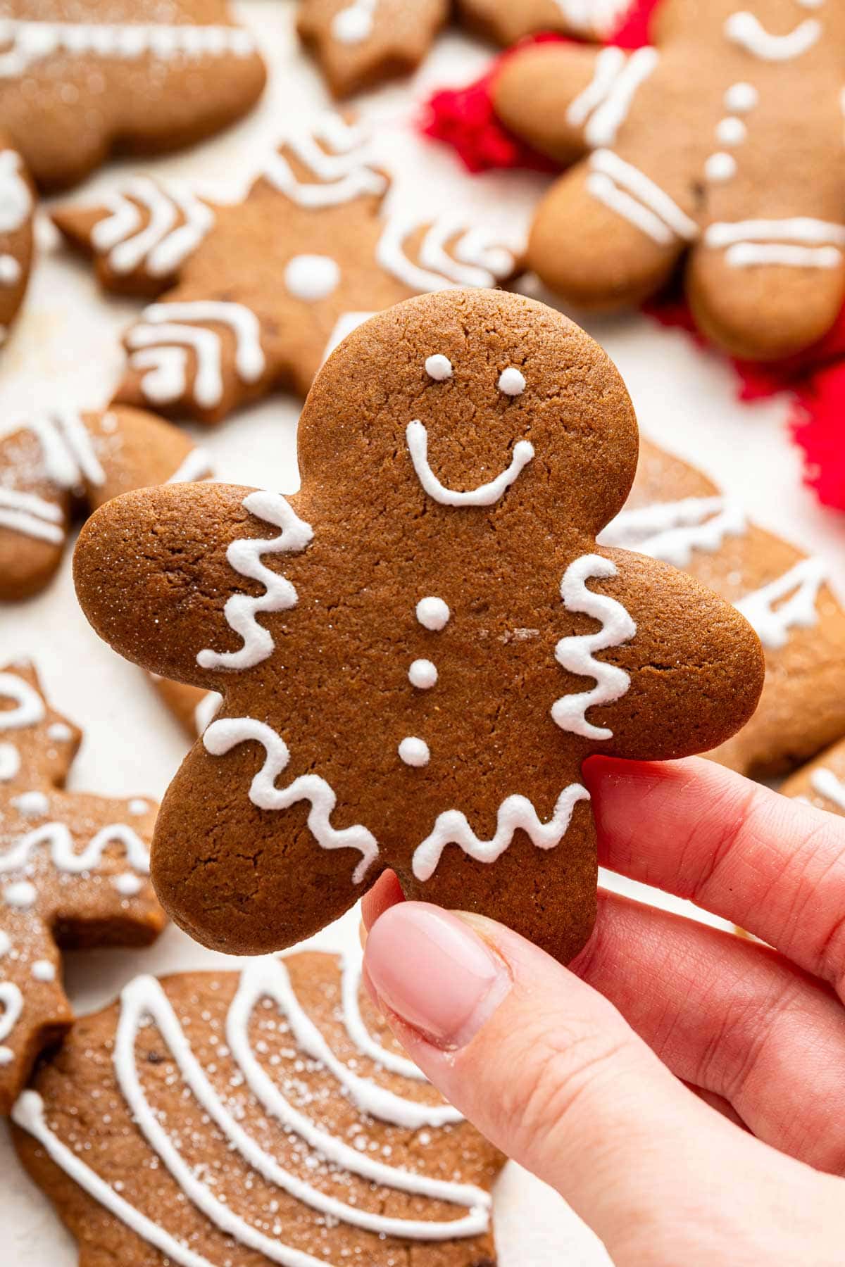 hand holding up a gingerbread cookie.
