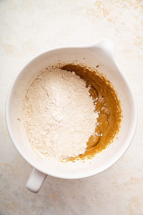 mixing wet ingredients into creamed butter and sugar.