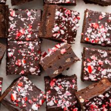 thick fudgy brownies covered with ganache and crushed candy canes.
