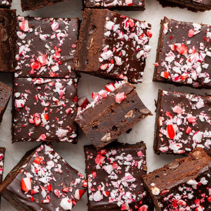 thick fudgy brownies covered with ganache and crushed candy canes.