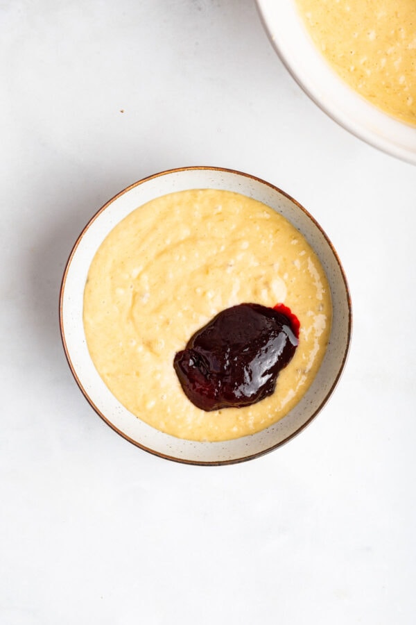 banana cake batter with a scoop of strawberry jam.