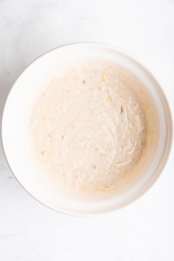 banana cake batter in a white mixing bowl.