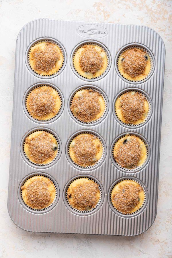 cinnamon sugar piled on top of muffin batter.