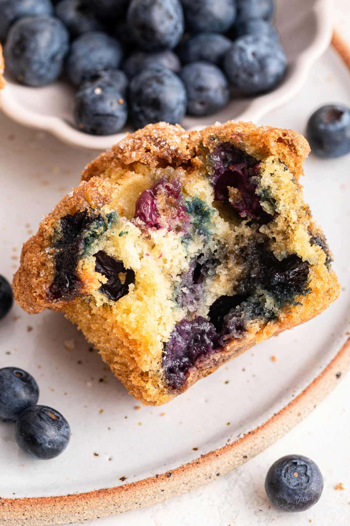 big muffin with a bite taken out of it showing the fluffy interior.