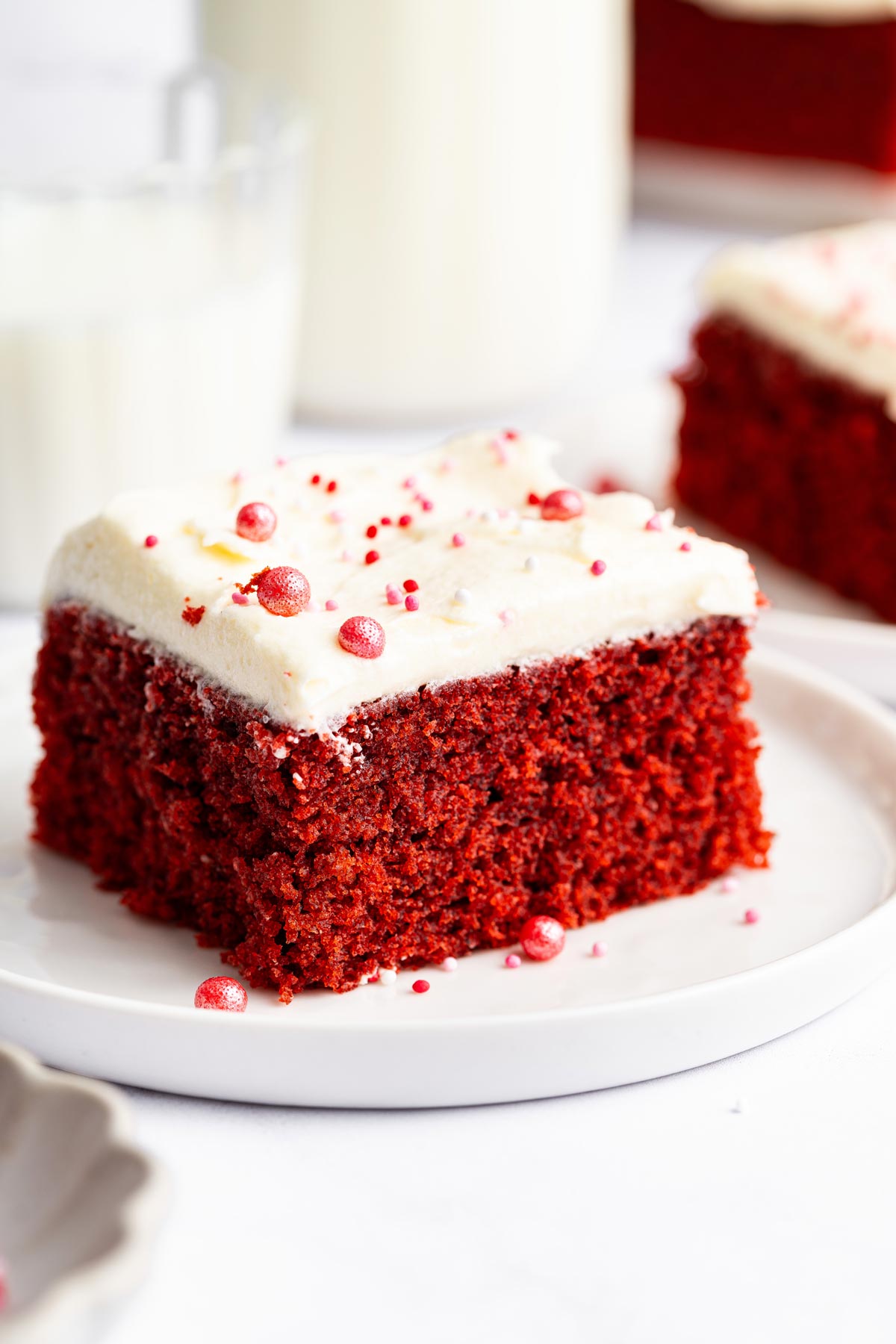 thick slice of red velvet bundt cake on a white dessert plate.