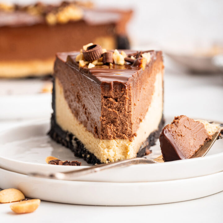 slice of chocolate peanut butter cheesecake with a forkful removed.