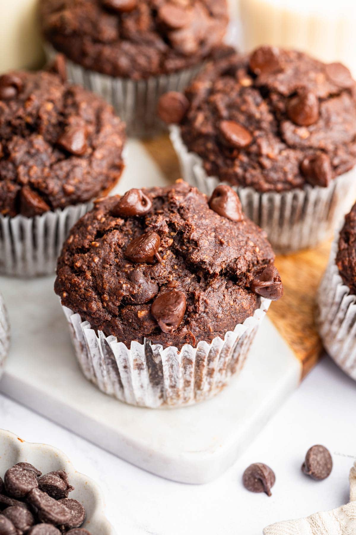 dairy free gluten free chocolate muffins in white paper liners.