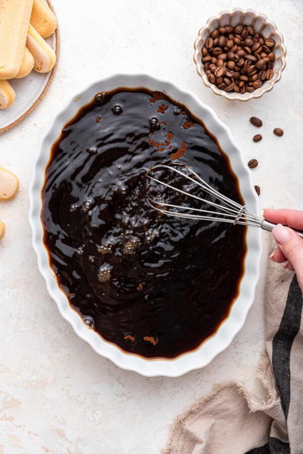 whisking the coffee dip for homemade tiramisu.