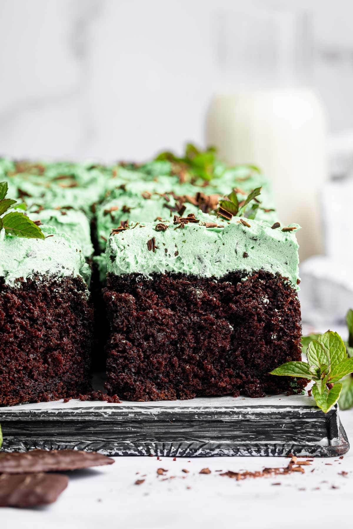 side view of a thick chocolate sheet cake with a layer of mint buttercream frosting.