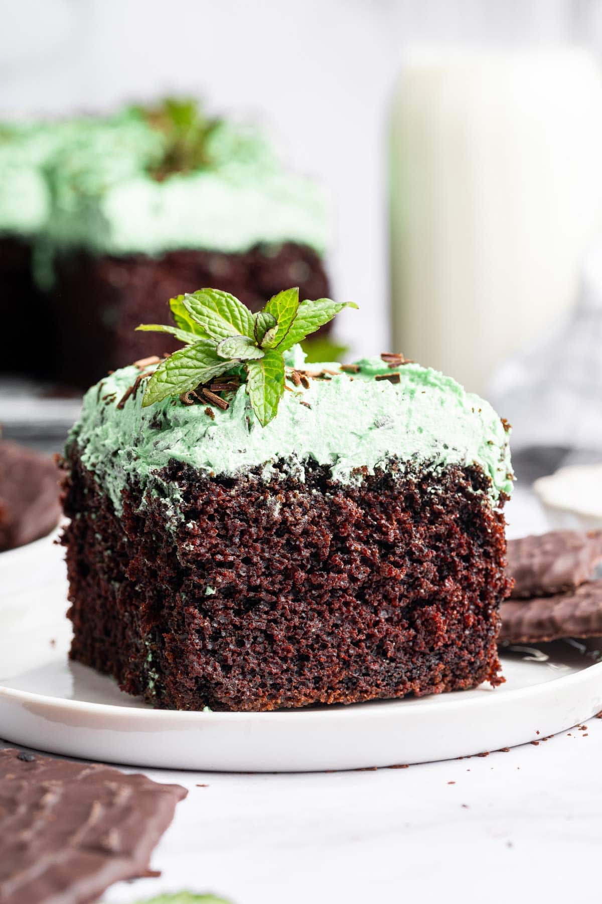 slice of mint chocolate chip sheet cake on a white dessert plate.