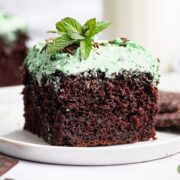 slice of thick and fluffy chocolate sheet cake topped with mint buttercream frosting.
