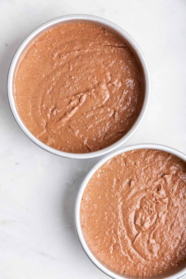 unbaked chocolate hazelnut cake in cake pans.