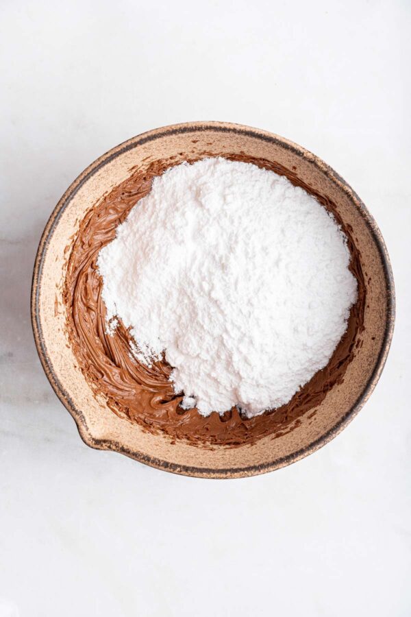 adding powdered sugar to nutella and butter.