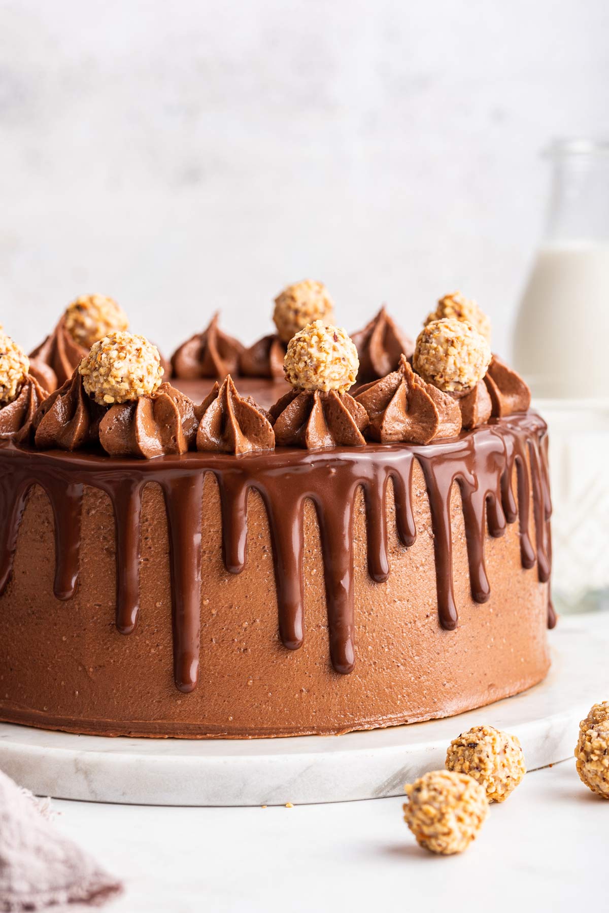 hazelnut cake covered with nutella frosting and drips of ganache.