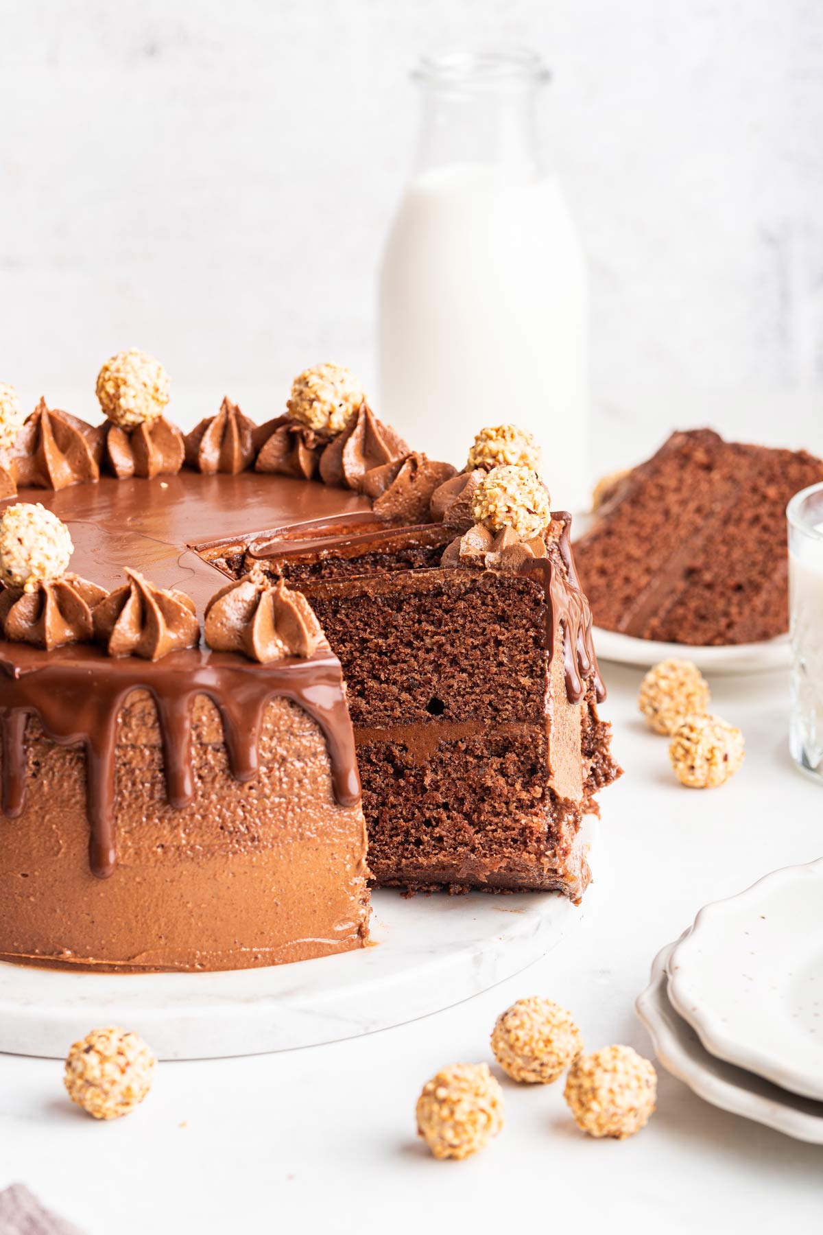 chocolate cake with a few slices removed and leaning against the cake.
