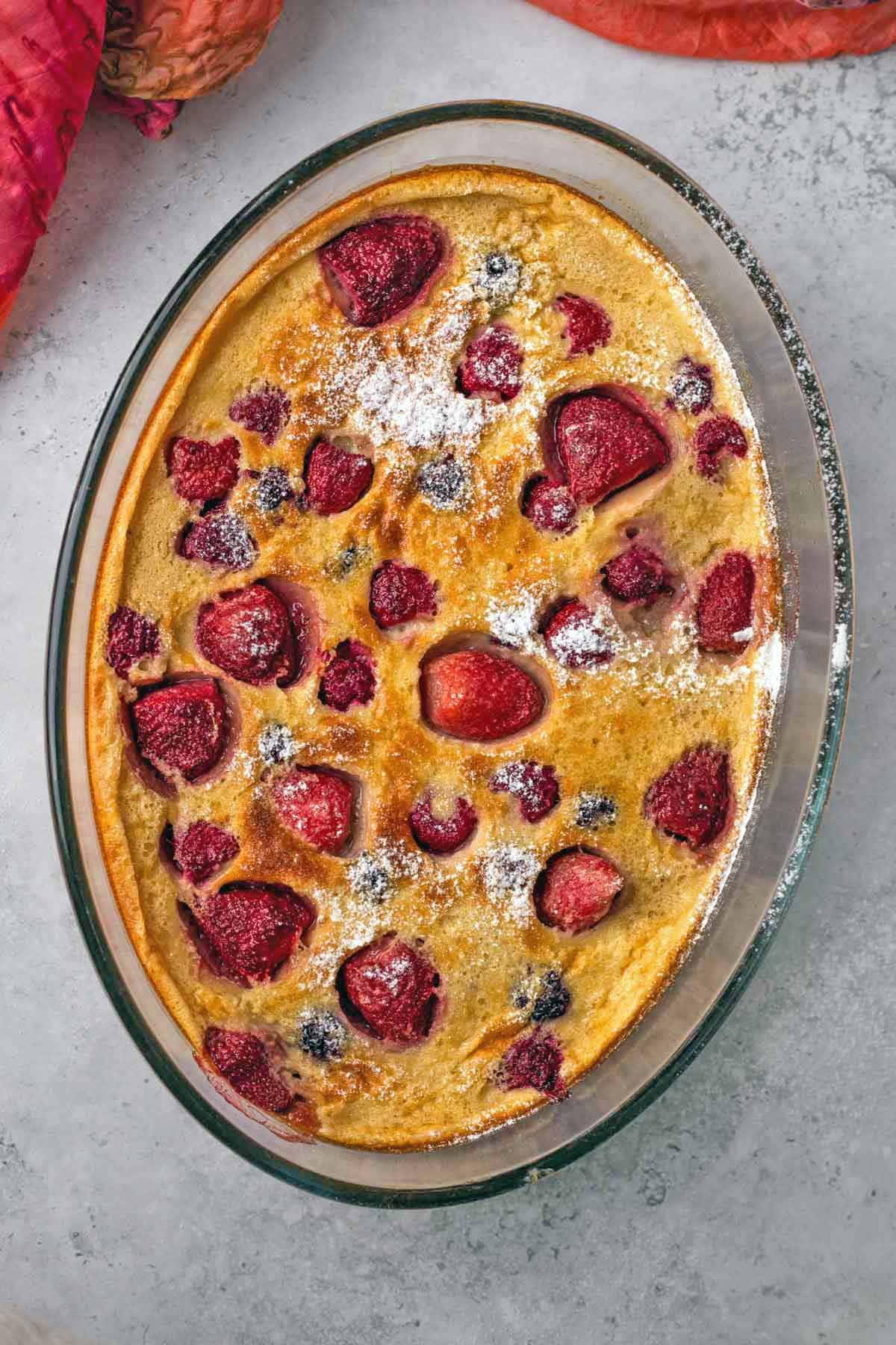 freshly baked clafoutis with strawberries, raspberries, and blackberries.