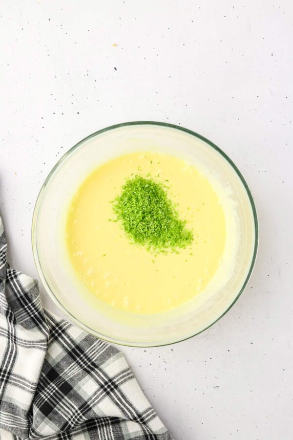 adding lime zest to key lie pie bars.