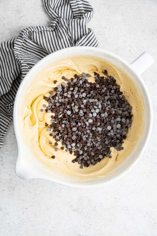 mini chocolate chips piled on top of a vanilla pound cake batter.