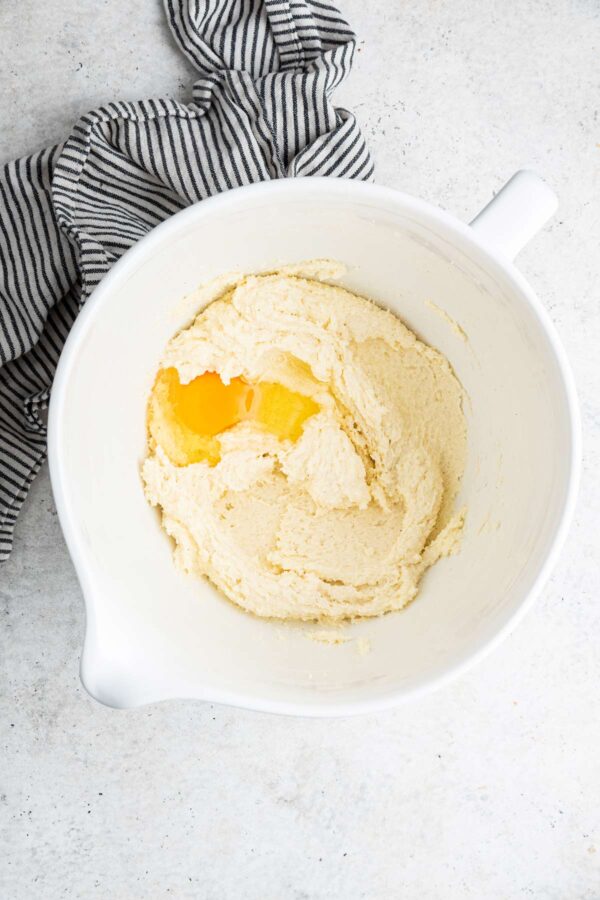 adding eggs into pound cake batter.