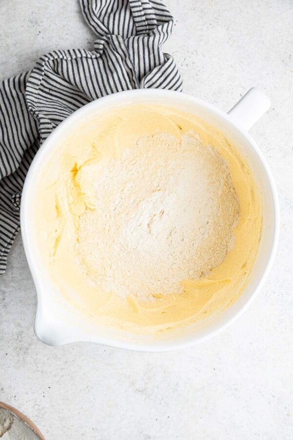 adding flour to cake batter.