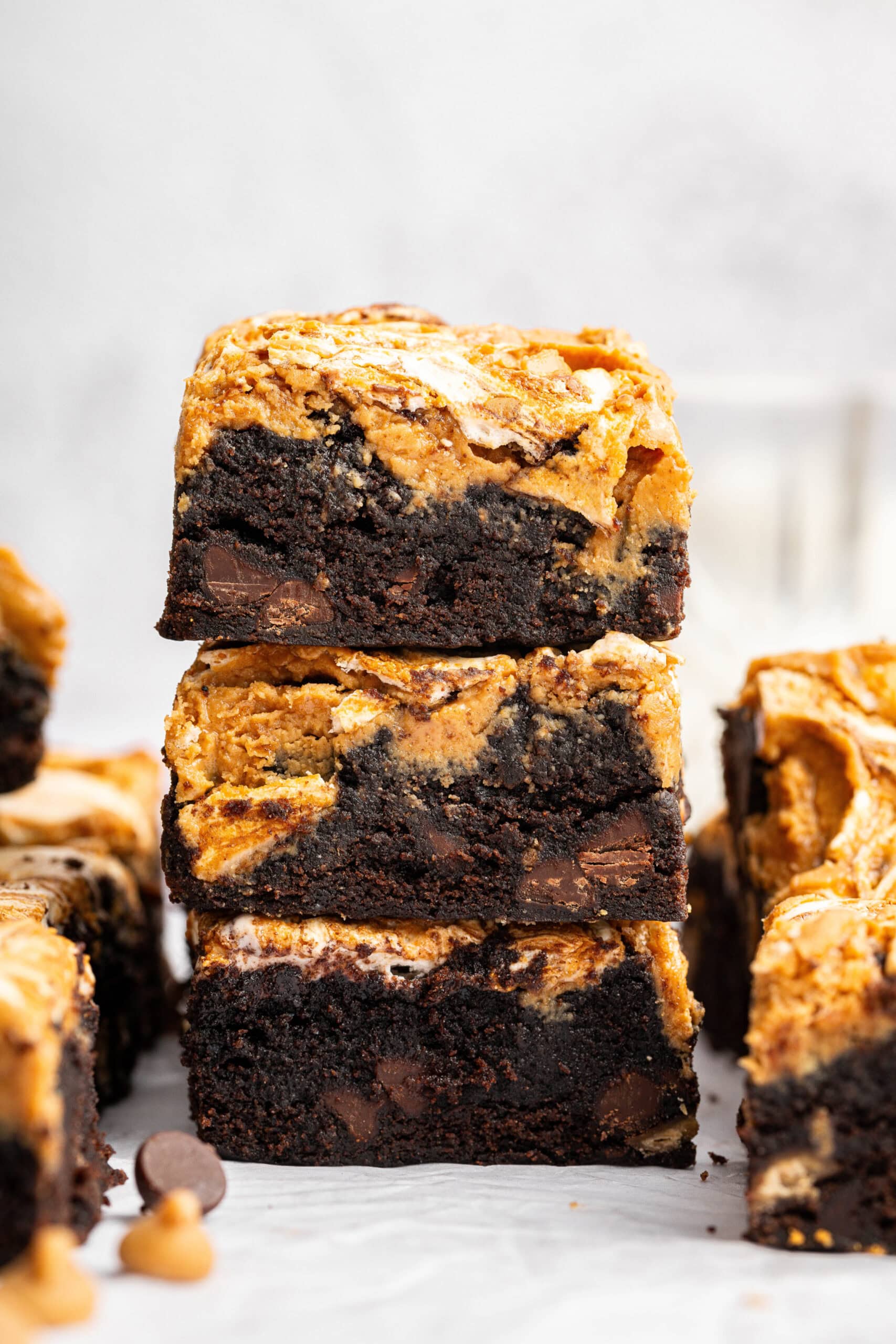 stack of three fluffernutter brownies showing the thick brownie base and layers of marshmallow and peanut butter.