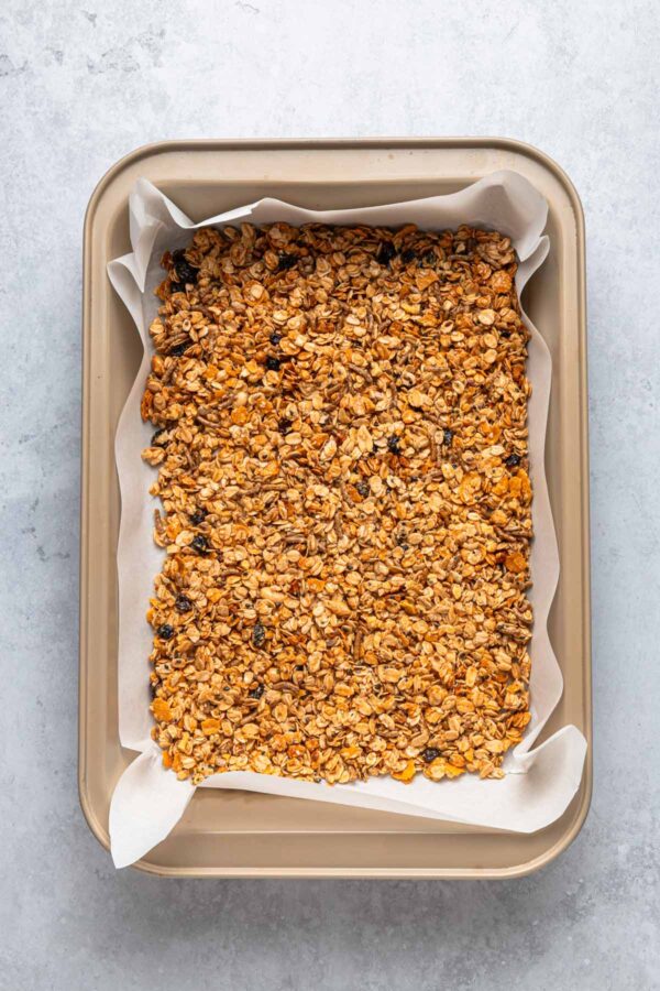 granola pressed into the bottom of a baking dish.