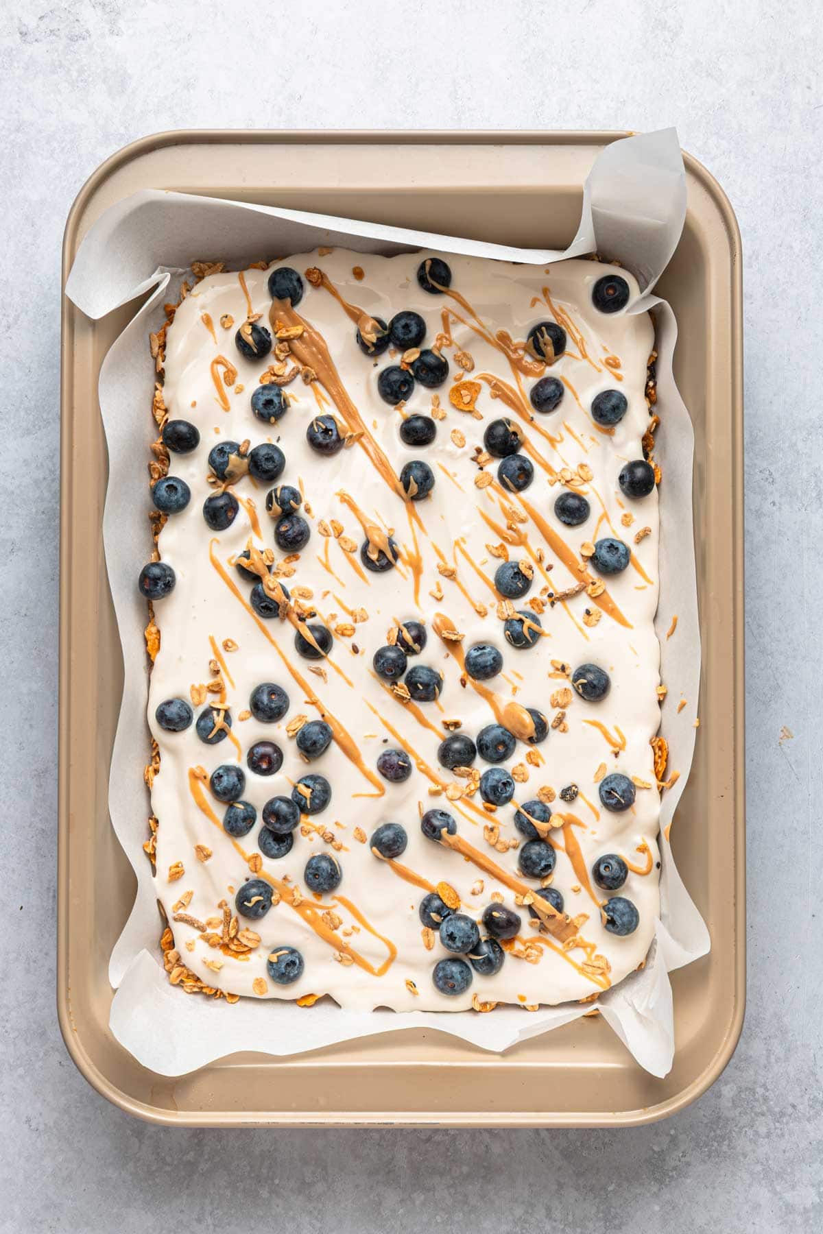 greek yogurt frozen on top of a granola base.
