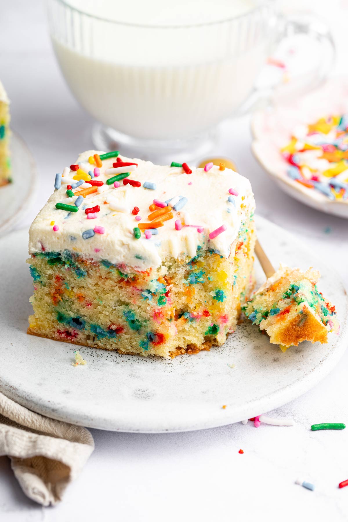 sprinkle-filled cake batter cake with one forkful of cake removed.