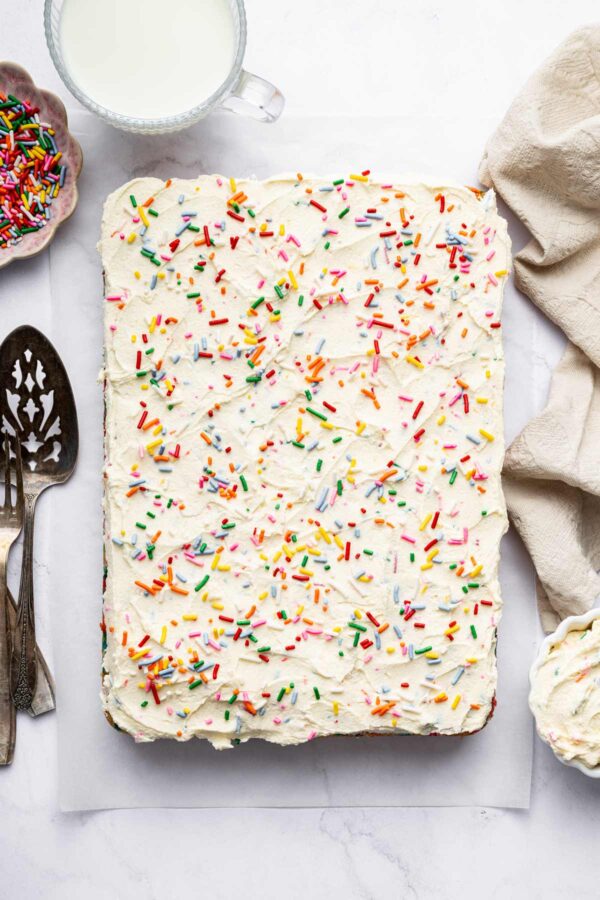 funfetti sheet cake decorated with frosting and extra sprinkles.