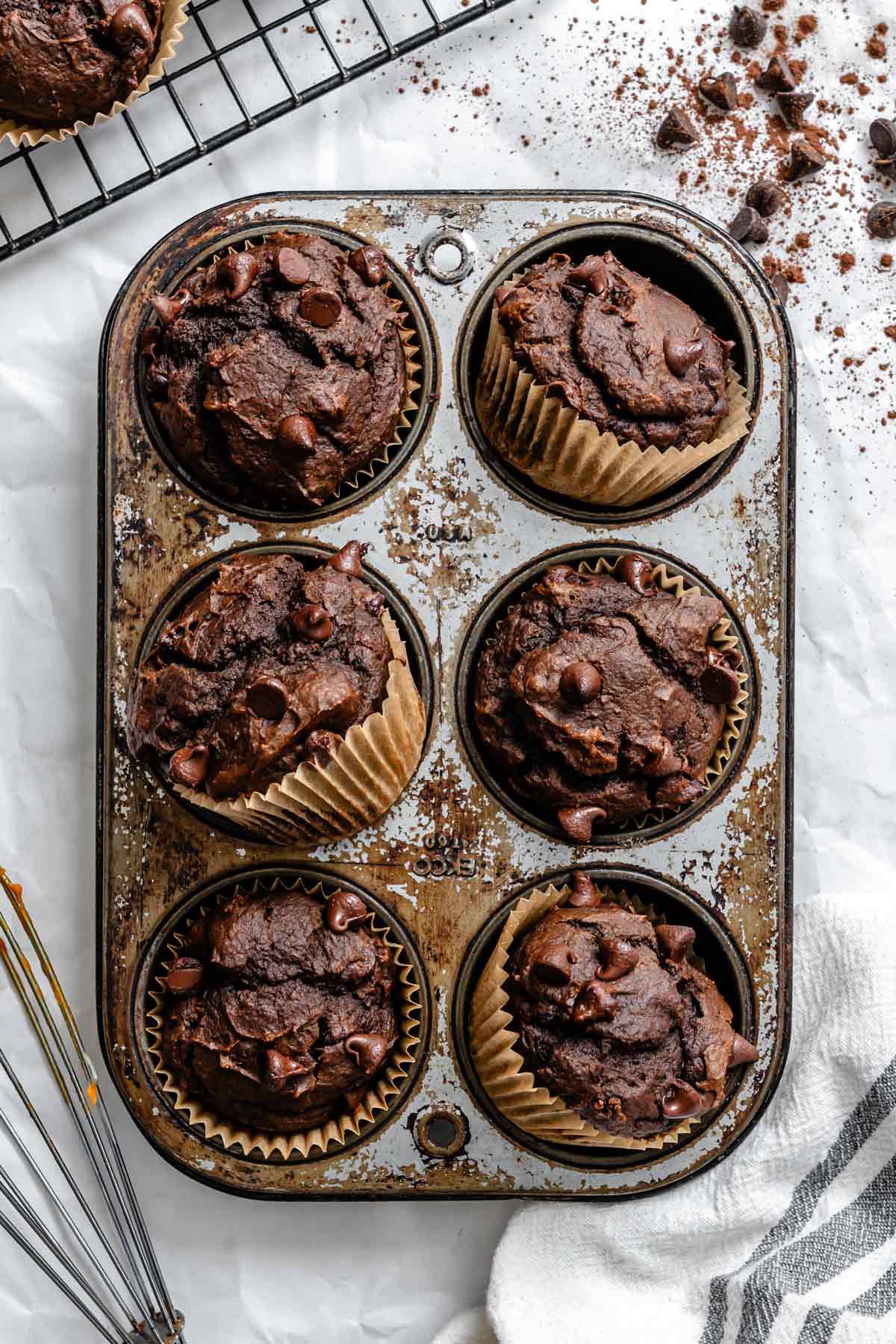 fudgy chocolate pumpkin muffins styled in a muffin tin.