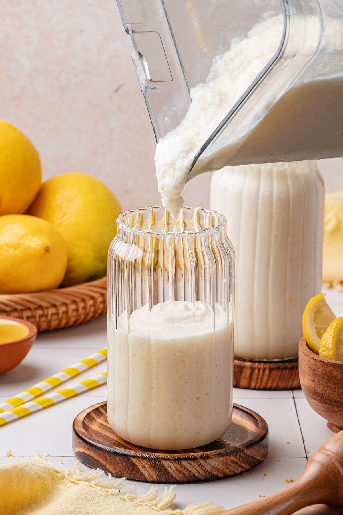 pouring frozen lemonade from a blender into a glass.