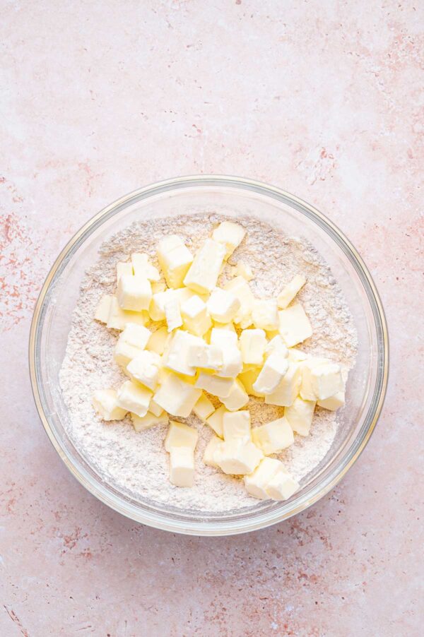 flour and sugar mixture with cubes of butter on top.