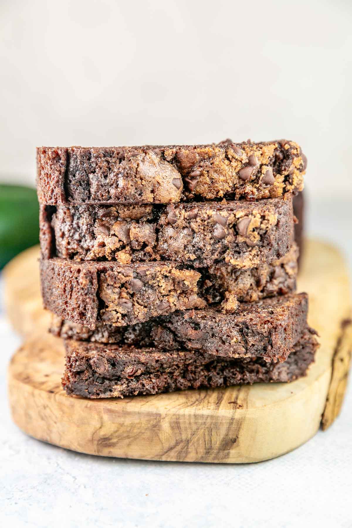 slices of chocolate zucchini bread with chocolate chip streusel stacked vertically.