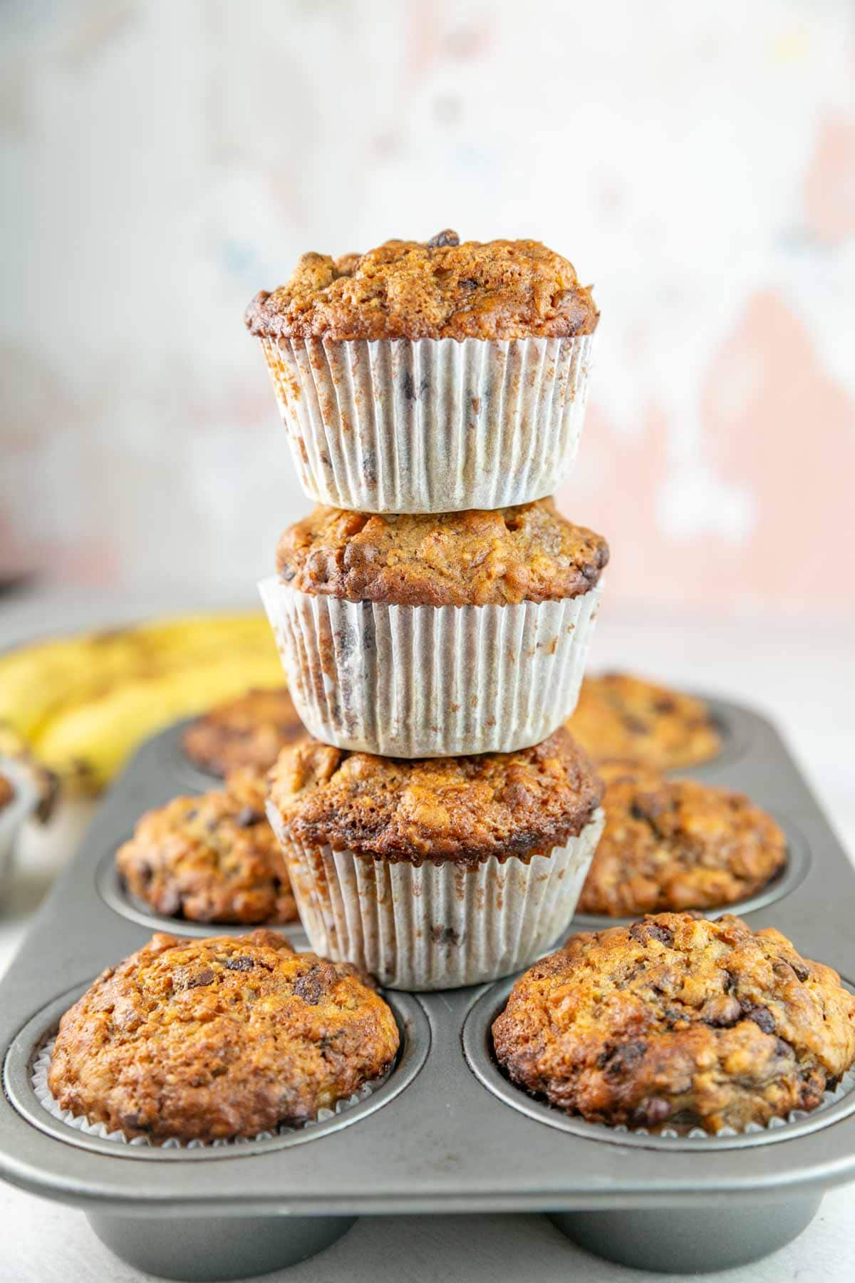 three muffins stacked on top of each other on a muffin tin.