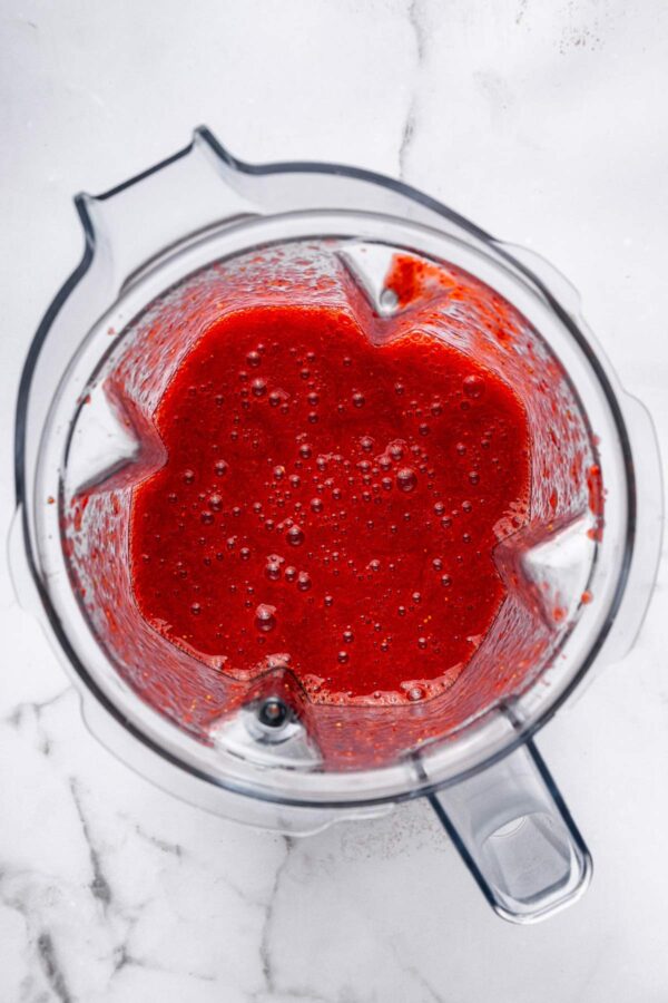 juicy pureed strawberries in a blender.