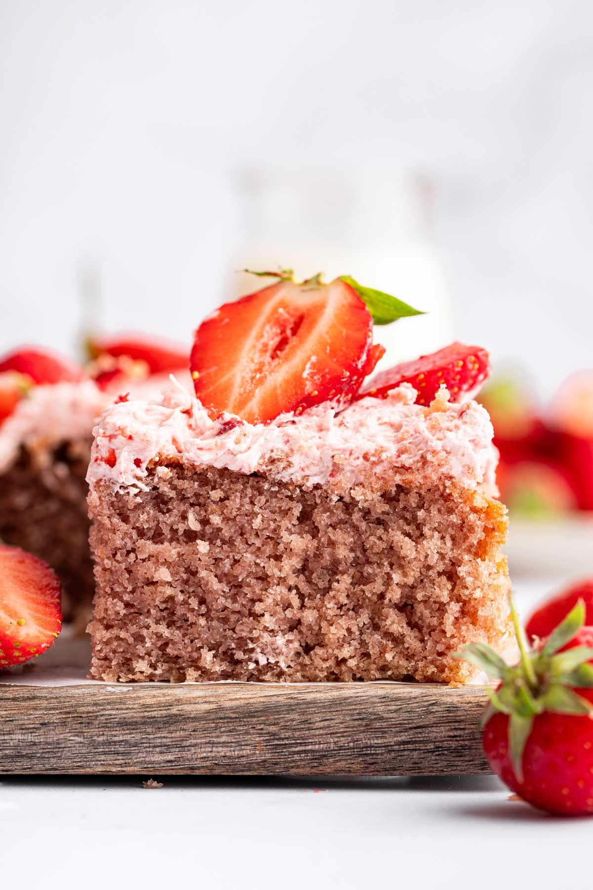 side view of a slice of strawberry cake showing the fluffy crumb interior.