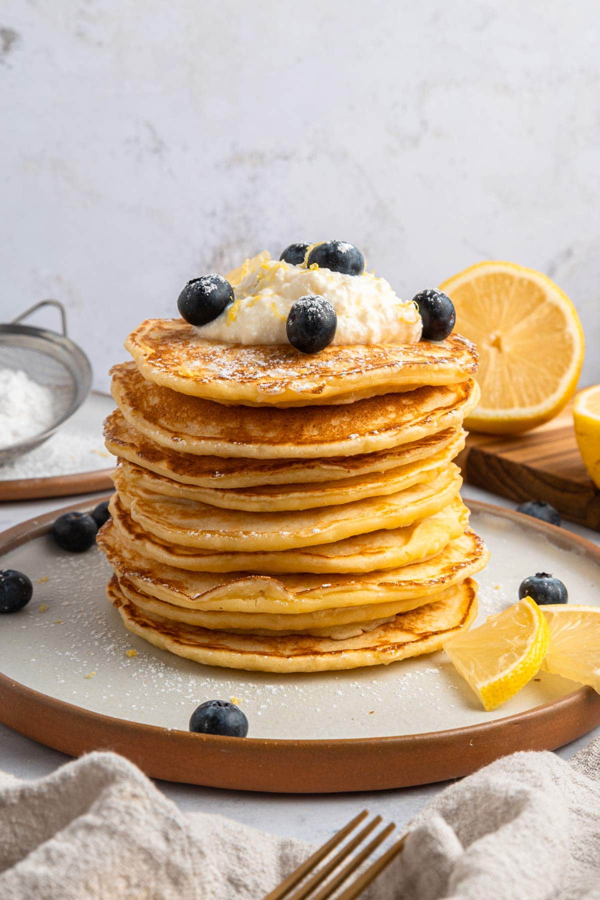 tall stack of fluffy lemon ricotta pancakes.