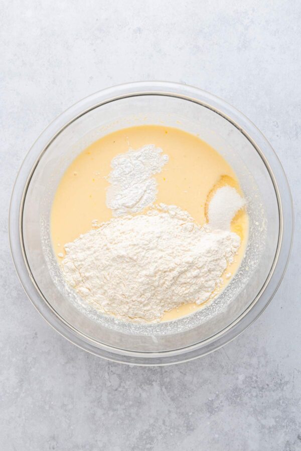 adding dry ingredients to lemon pancake batter.