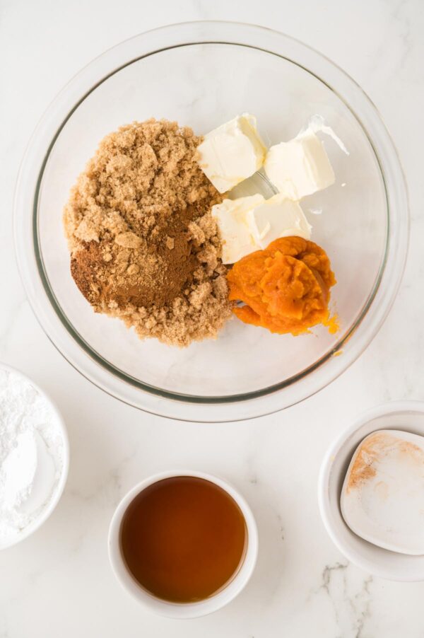 butter, sugar, spices, and pumpkin puree in a mixing bowl.