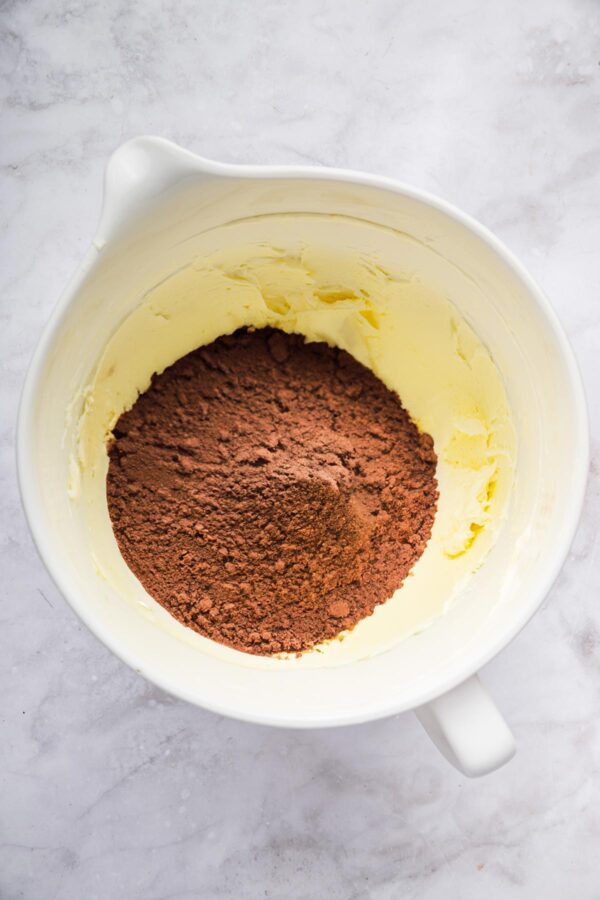 cocoa powder on top of whipped butter to make frosting.