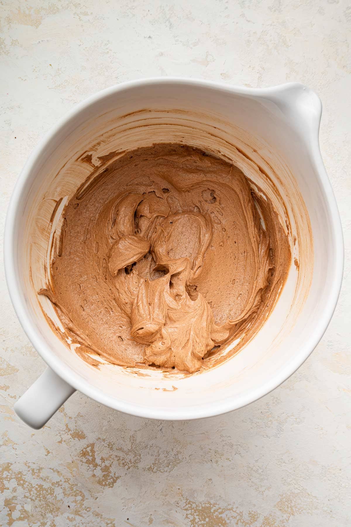 light and fluffy whipped buttercream frosting in a mixing bowl.