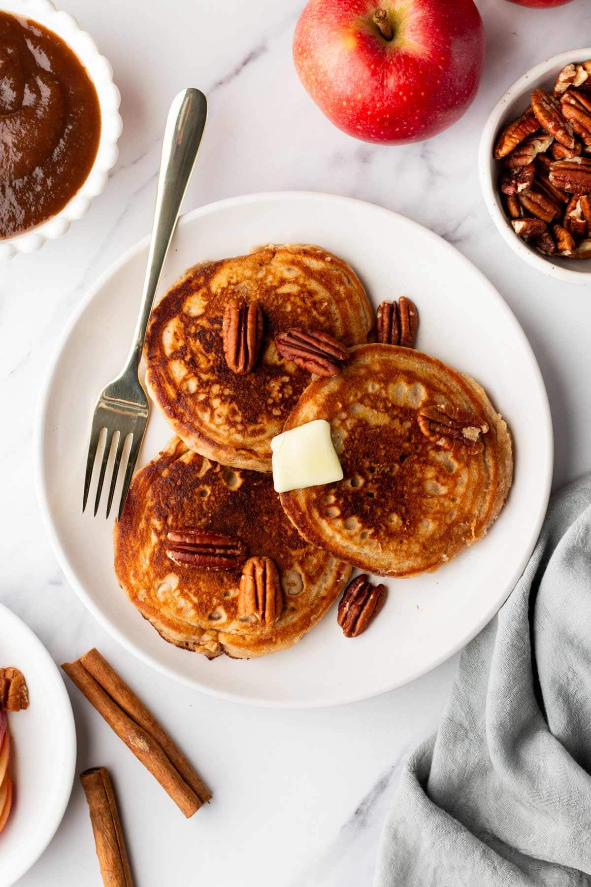 apple butter pancakes with butter and toasted pecans.